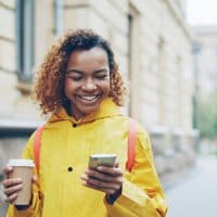 Pilot member with a coffee, checking her phone