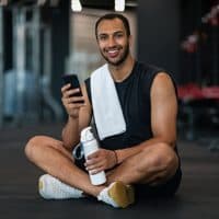 Member of the GeoMine team with a phone
